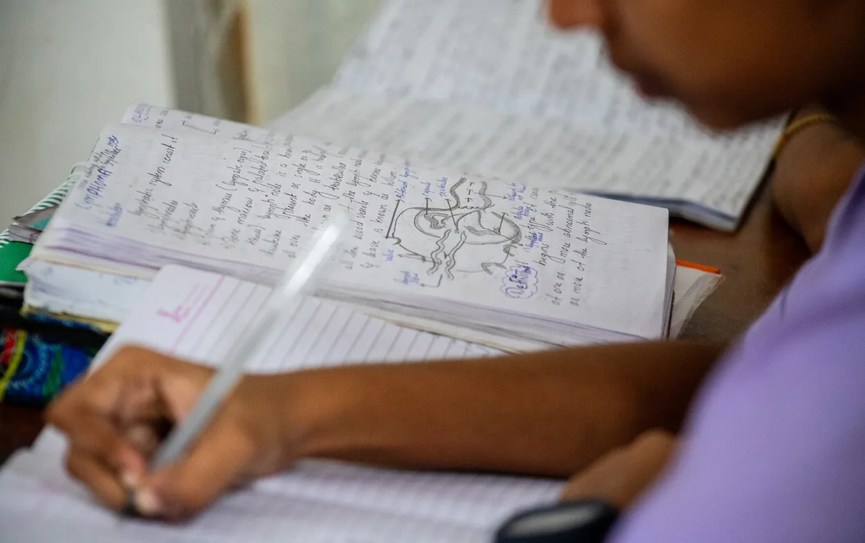 Facilities - Study Skills Student writing in notebook